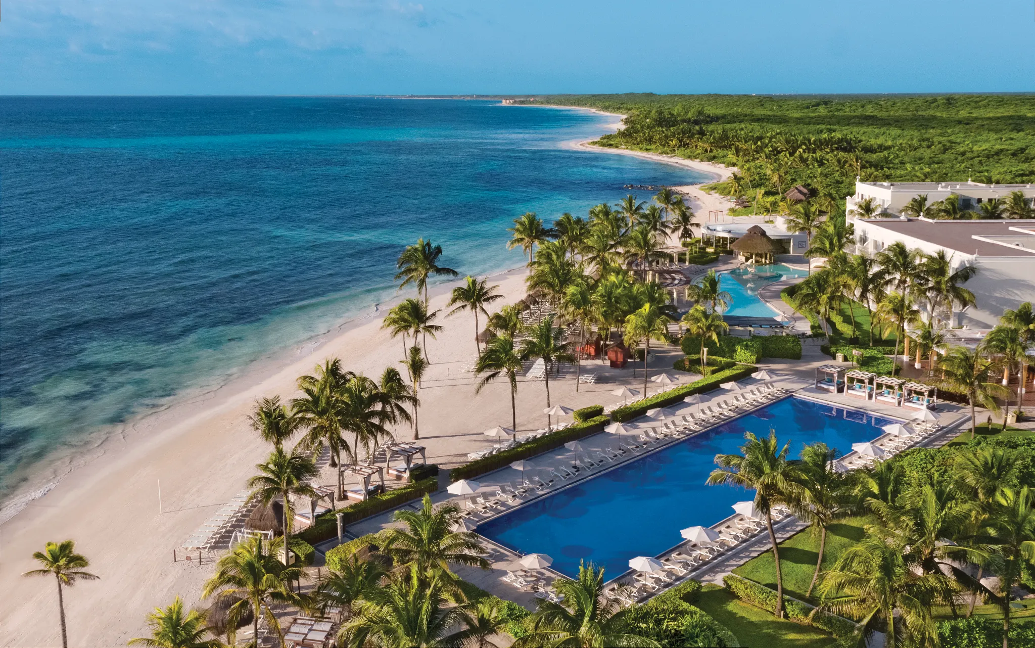 Aerial view of pools, beachfront, and tropical grounds at Dreams Tulum Resort & Spa.