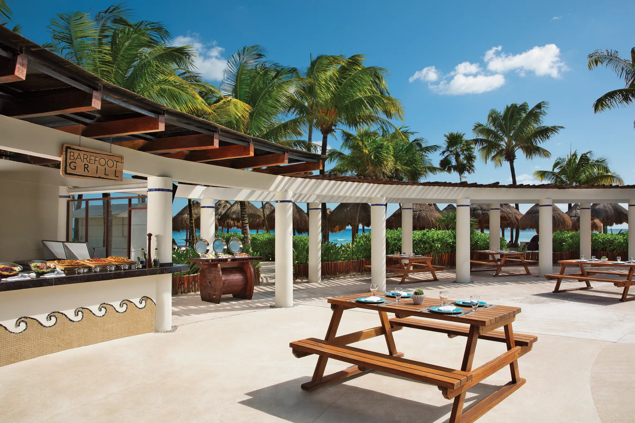 Barefoot Grill at Dreams Tulum Resort & Spa featuring a casual open-air dining setting with grilled favorites served near the pool and beach.