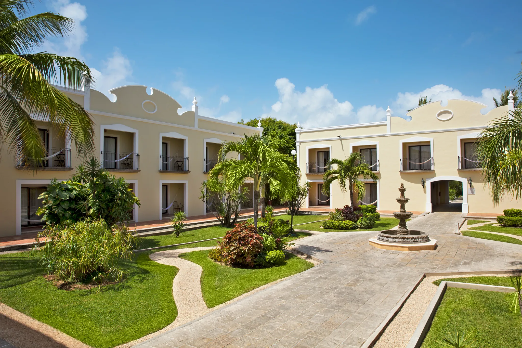 Elegant courtyard with fountain and tropical landscaping at Dreams Tulum Resort & Spa in Riviera Maya.