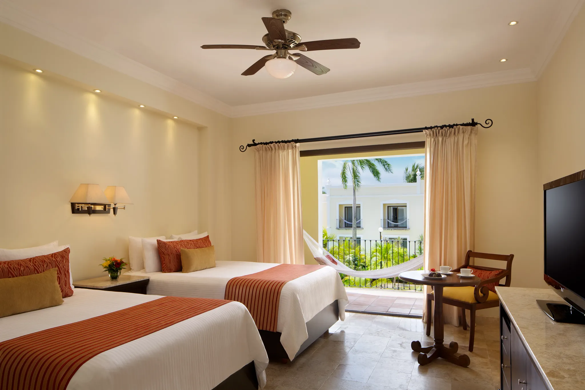 Deluxe Garden View Adults-Only room with two double beds and furnished balcony at Dreams Tulum Resort & Spa.