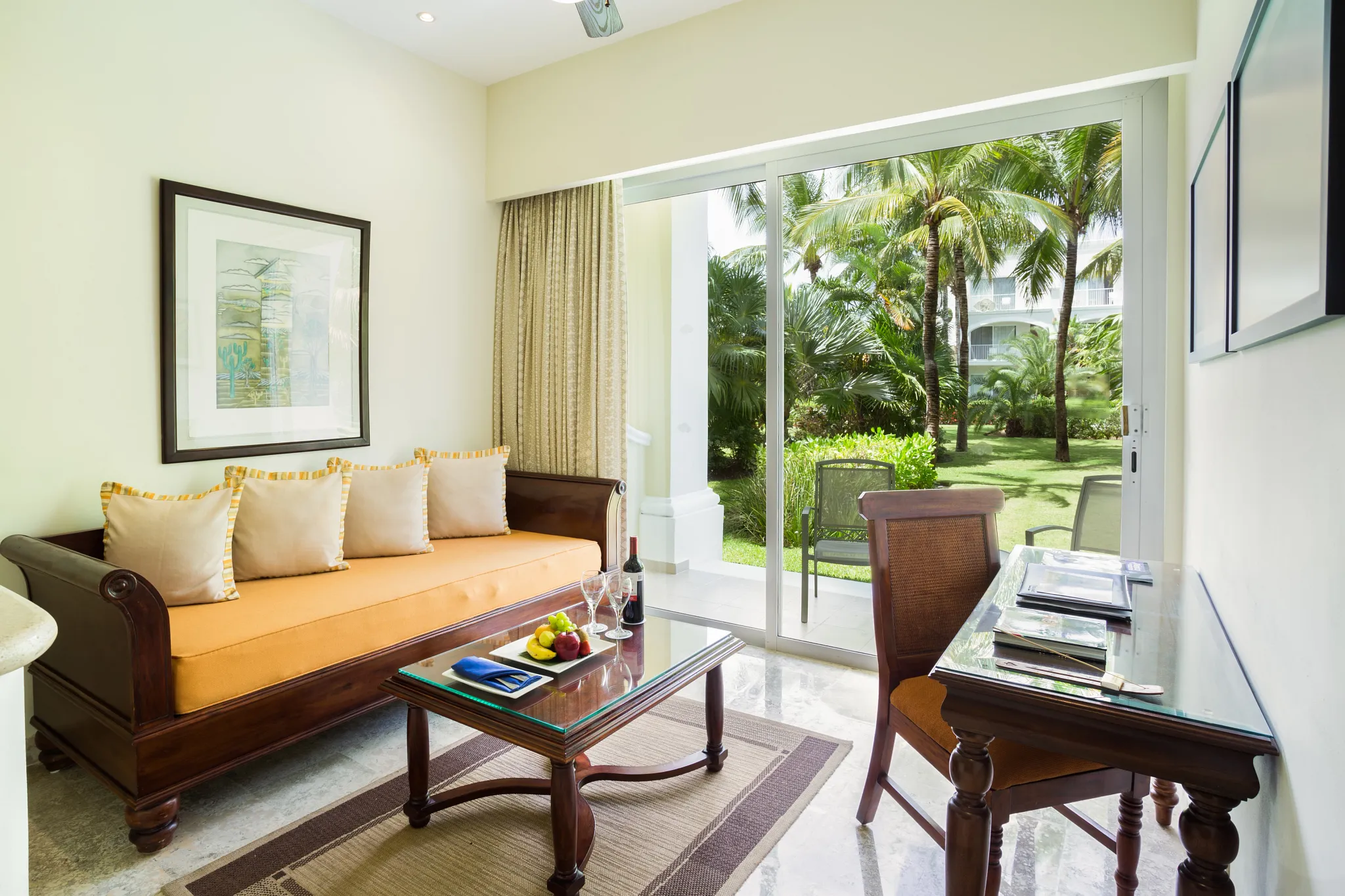Deluxe Junior Garden View living area with sofa and terrace access at Dreams Tulum Resort & Spa.