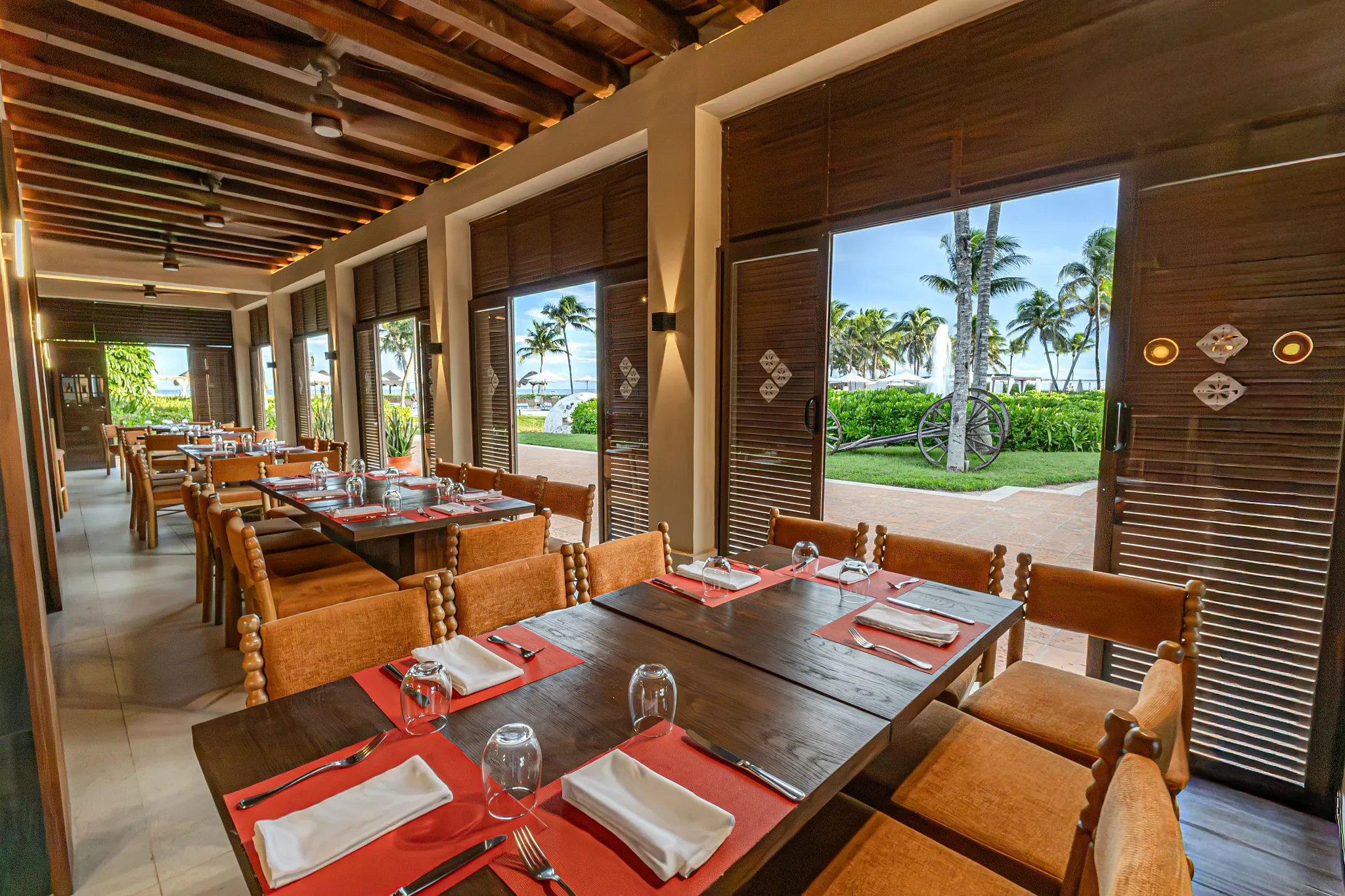 El Patio restaurant at Dreams Tulum Resort & Spa featuring vibrant Mexican-inspired décor, authentic cuisine, and a warm hacienda-style atmosphere.
