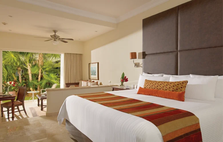 Junior Suite Garden View with king bed and spacious sitting area at Dreams Tulum Resort & Spa.