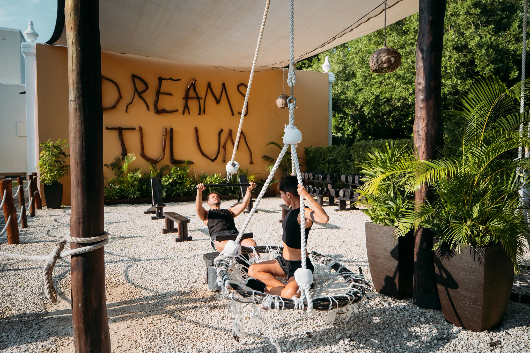 Guests exercising in the outdoor fitness area at Dreams Tulum Resort & Spa’s Dreams Tulum Fitness Center.