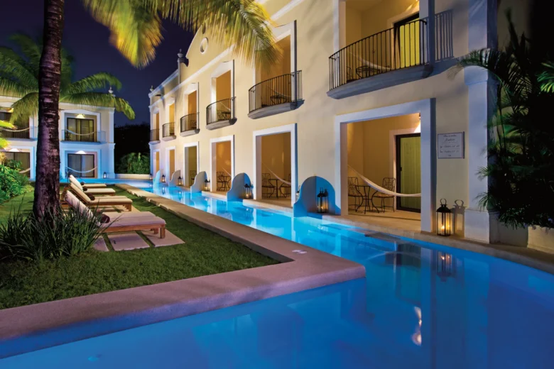 Adults-only Preferred Club Deluxe Garden Swim Out suites with illuminated swim-out pool at Dreams Tulum Resort & Spa at night.