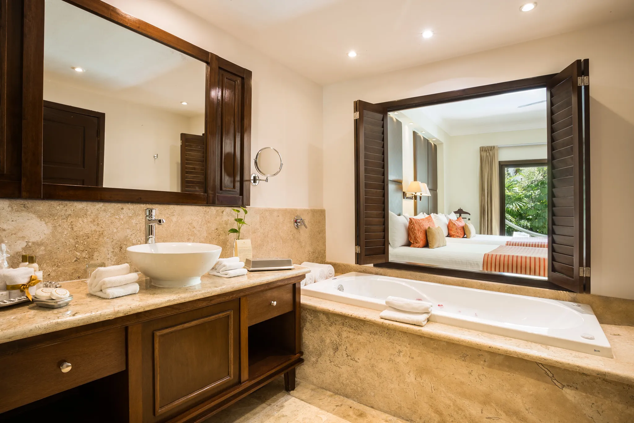 Preferred Club Deluxe Garden Swim Out marble bathroom with soaking tub and vanity at Dreams Tulum Resort & Spa.