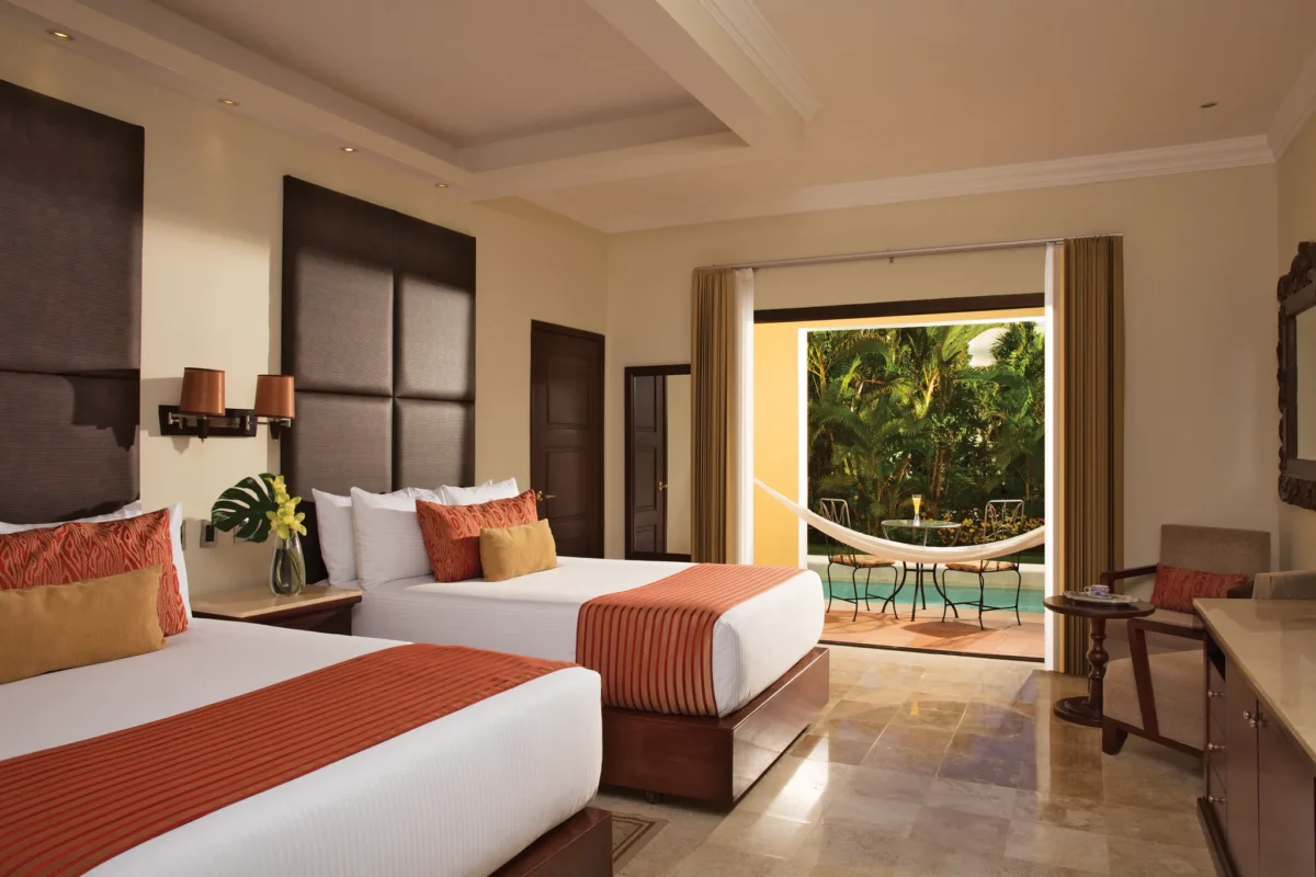 Preferred Club Deluxe Garden Swim Out room with two double beds and swim-out terrace at Dreams Tulum Resort & Spa.