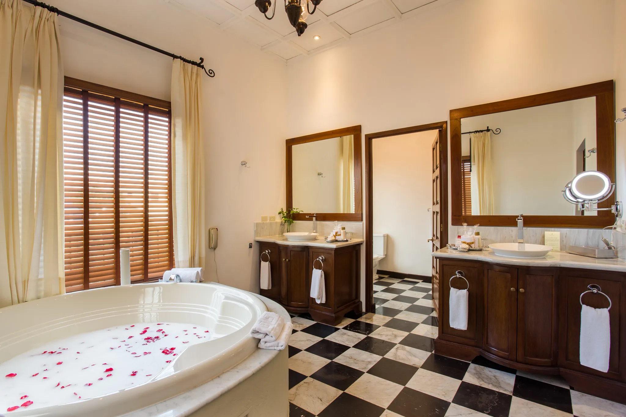 Preferred Club Hacienda Presidential Suite bathroom with hot tub, double vanities, and marble finishes at Dreams Tulum Resort & Spa.