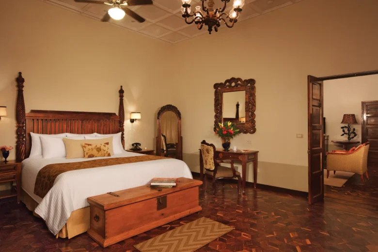 Preferred Club Hacienda Presidential Suite bedroom with king bed and elegant Mexican décor at Dreams Tulum Resort & Spa.