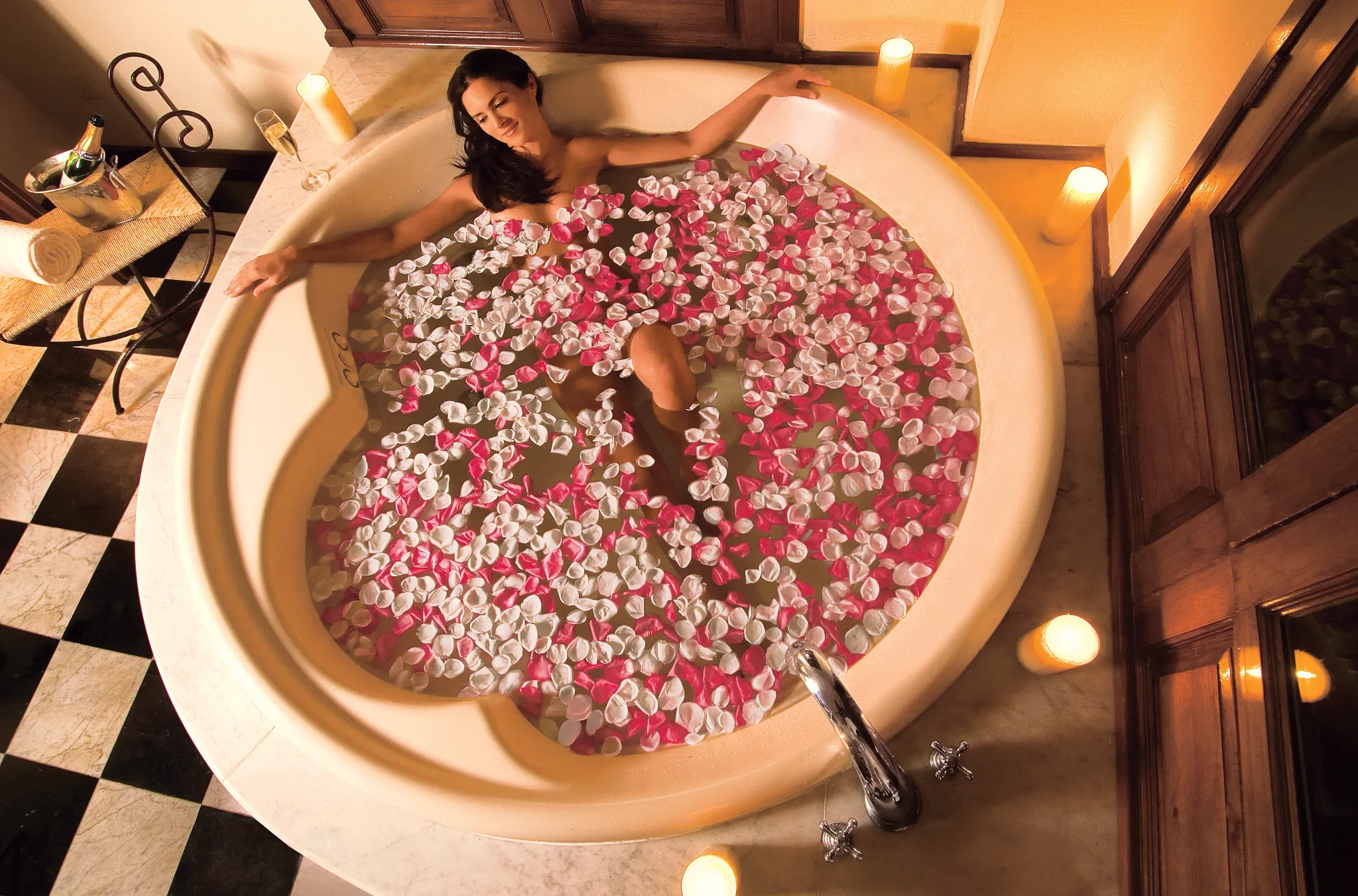Romantic hot tub experience with rose petals in the Preferred Club Hacienda Presidential Suite at Dreams Tulum Resort & Spa.