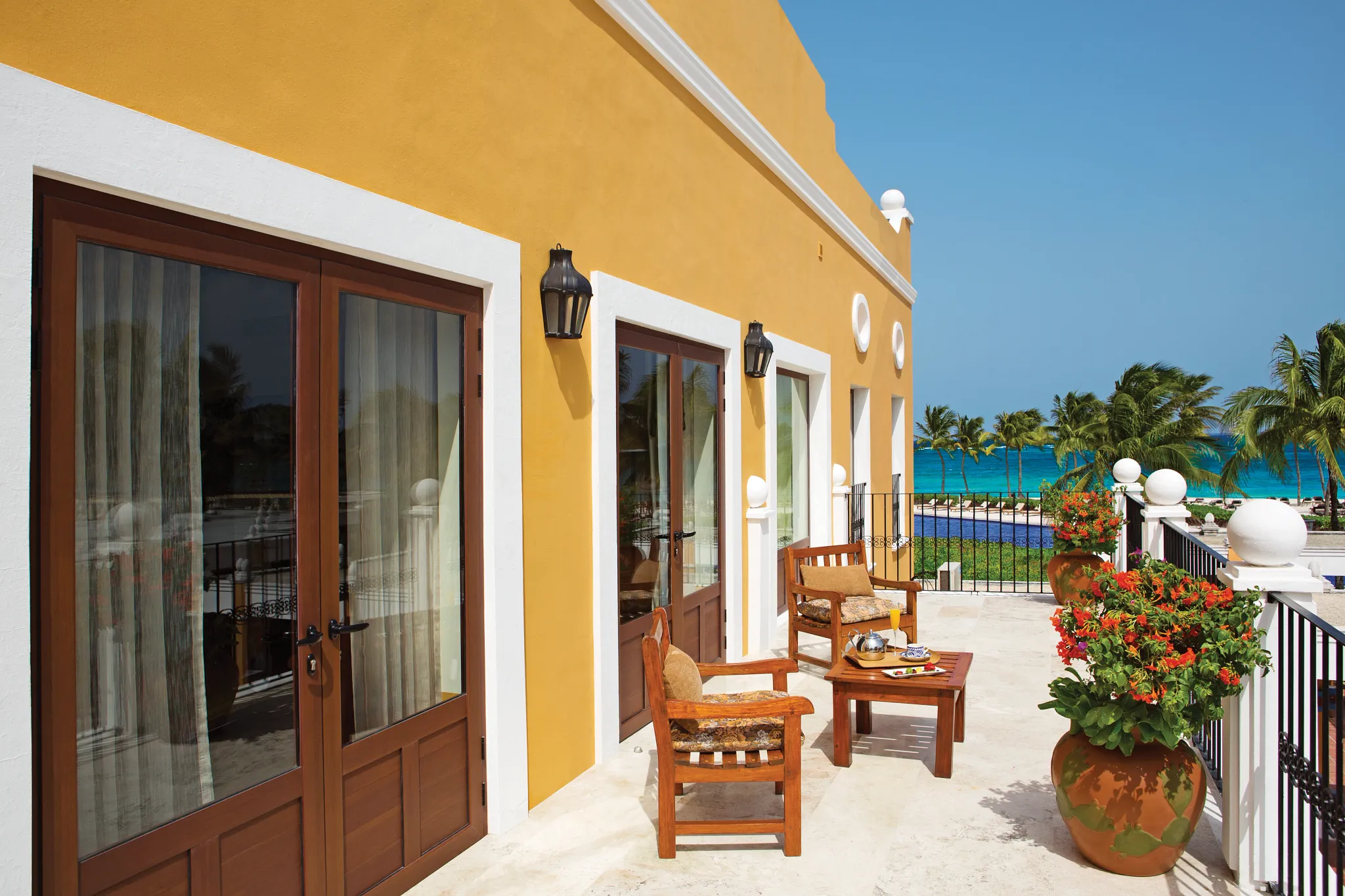 Private terrace of the Preferred Club Hacienda Presidential Suite overlooking tropical gardens and the Caribbean Sea at Dreams Tulum.