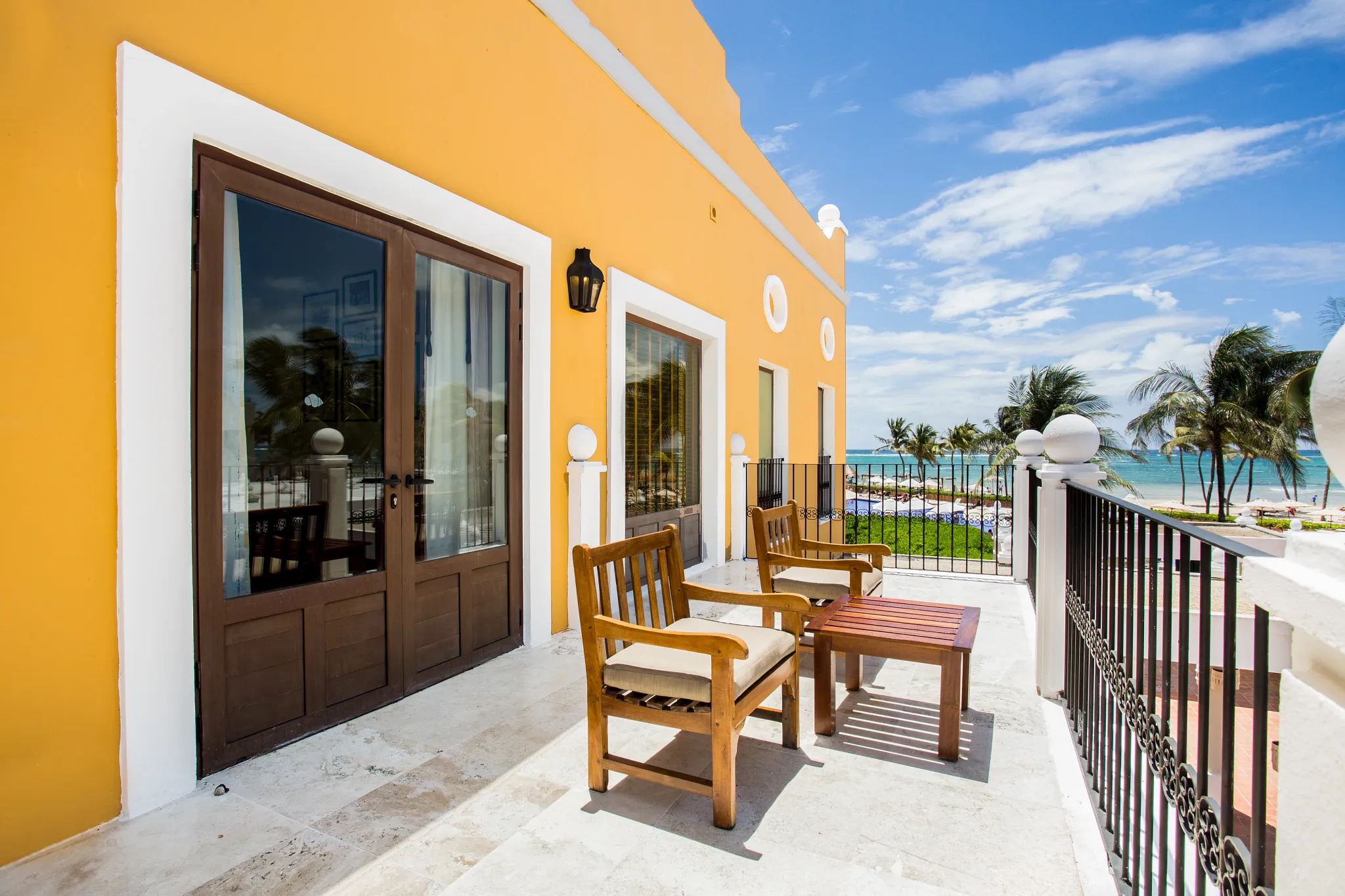 Private furnished balcony with ocean views at the Preferred Club Hacienda Suite in Dreams Tulum Resort & Spa.
