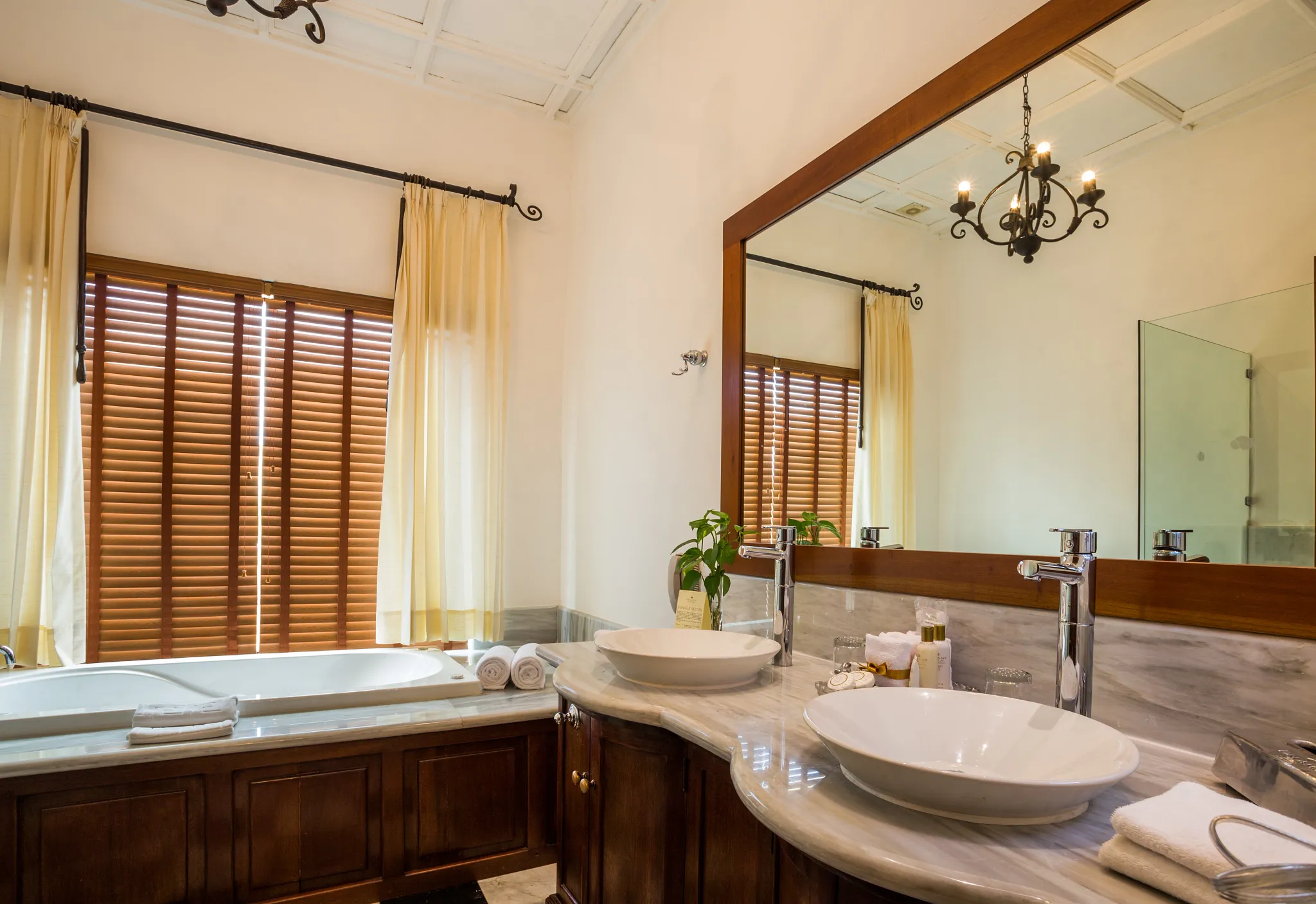 Full bathroom with double vanity, hot tub, and elegant marble finishes in the Preferred Club Hacienda Suite.