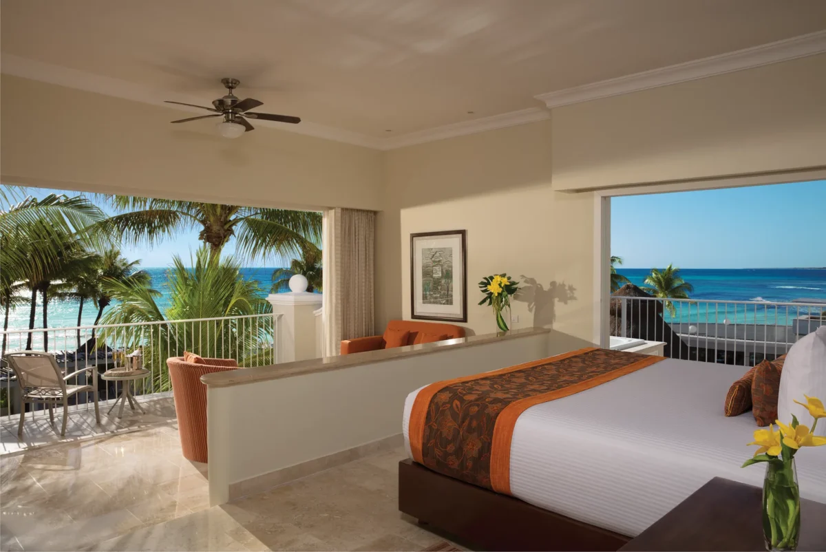 Preferred Club Honeymoon Suite Ocean Front with king-size bed, sitting area, and private balcony overlooking the Caribbean Sea at Dreams Tulum Resort & Spa.