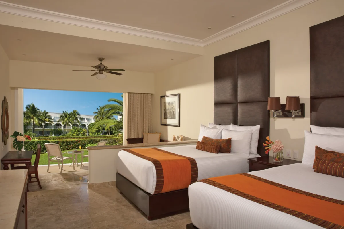 Preferred Club Junior Suite Garden View with two double beds and terrace access at Dreams Tulum Resort & Spa.