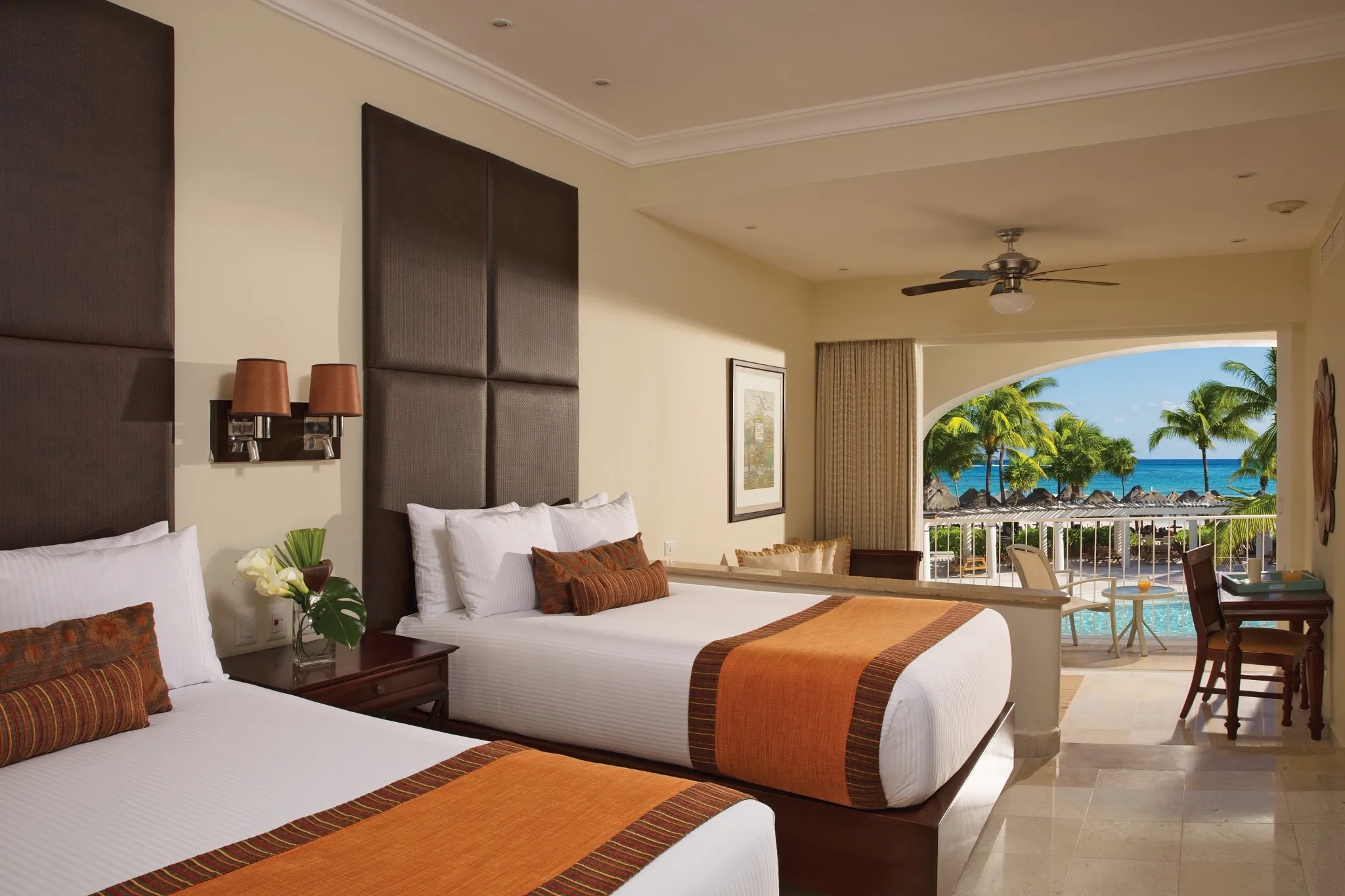Preferred Club Junior Suite Ocean Front with two double beds and a furnished balcony overlooking the ocean at Dreams Tulum Resort & Spa.