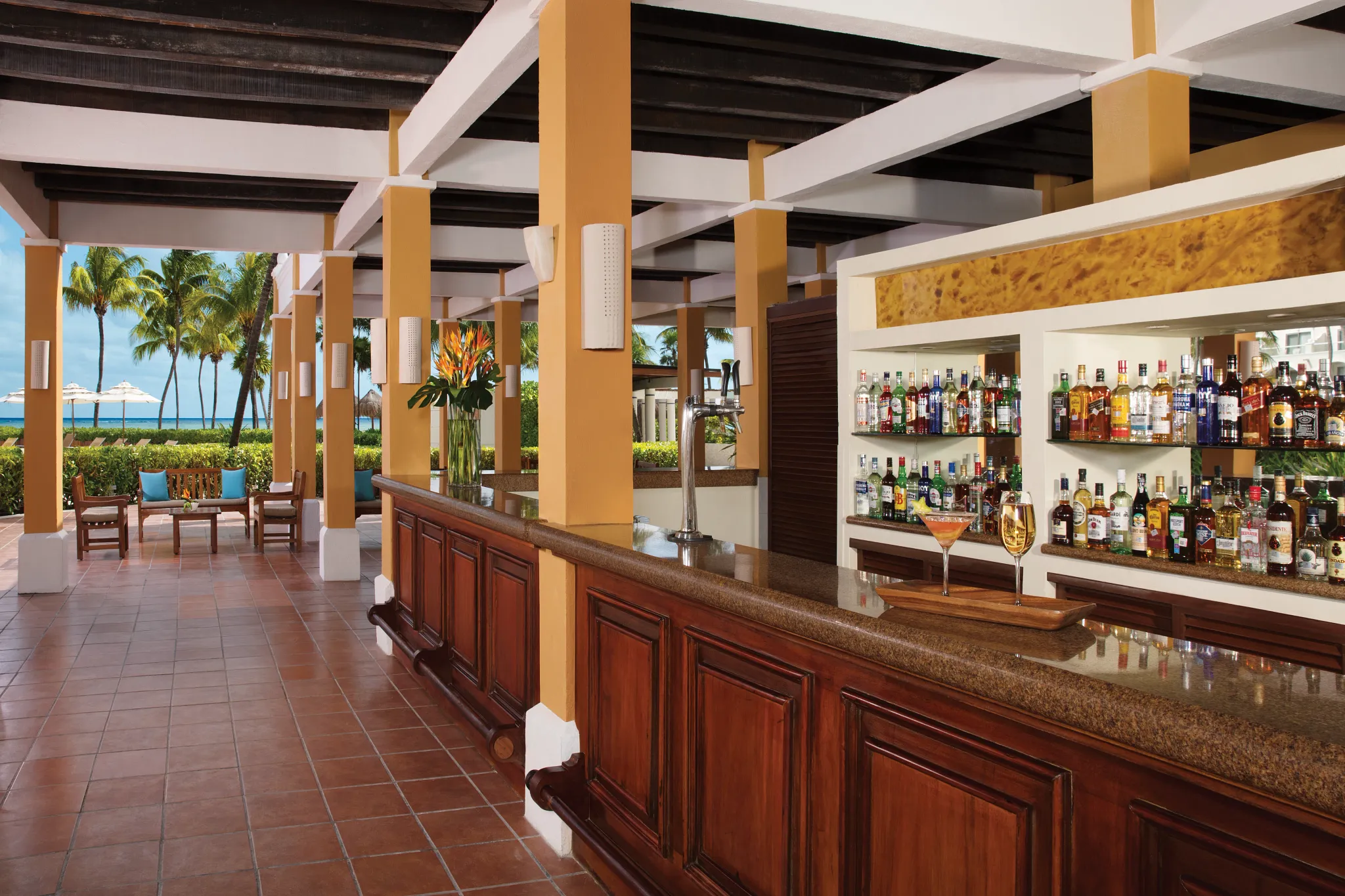Sugar Reef pool bar at Dreams Tulum Resort & Spa featuring tropical cocktails, swim-up service, and a relaxed poolside atmosphere surrounded by lush gardens.
