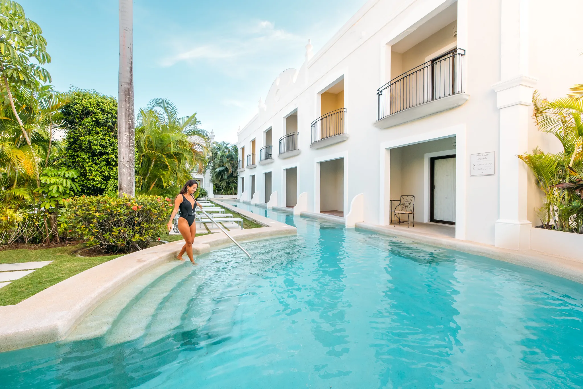 Guest enjoying direct pool access from a swim-out suite at Dreams Tulum Resort & Spa.